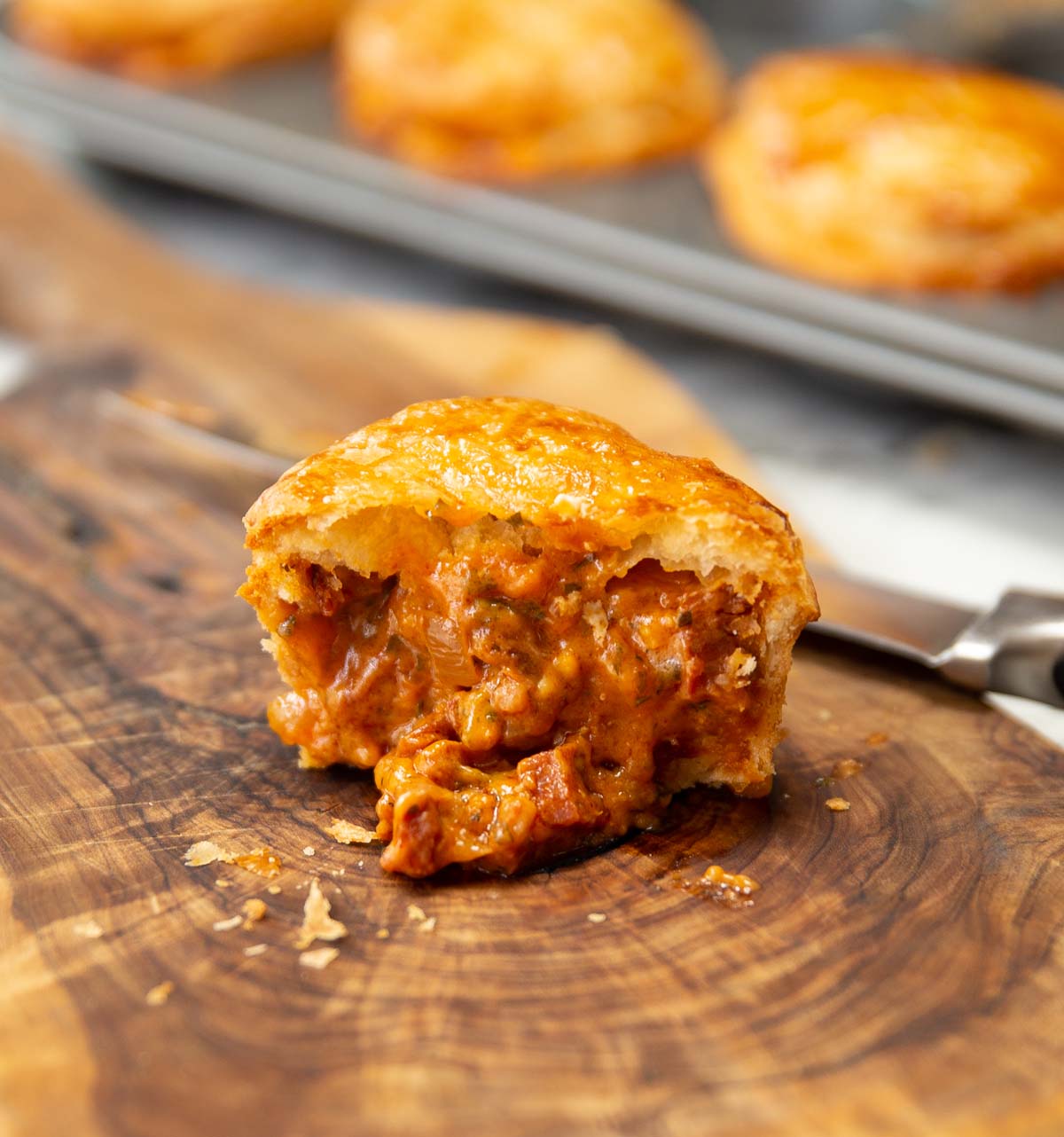 close up shot of chicken chorizo pie with filling pouring out
