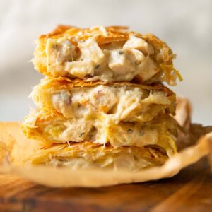 4 halved boursin bakes stacked on each other on wooden board